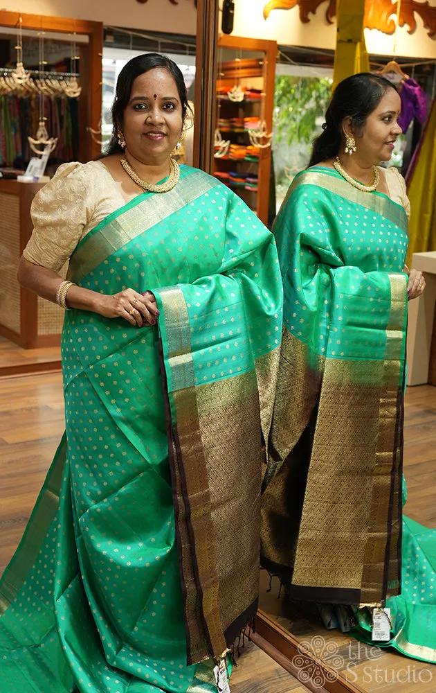 Teal green soft silk saree with small zari buttas